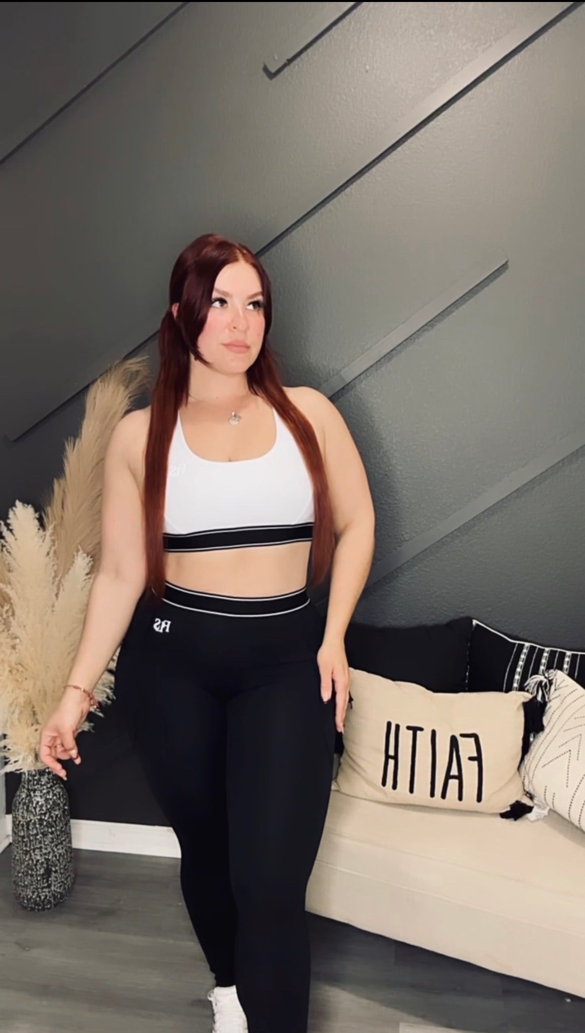 Model wearing Alexandria-sport-set Alexandria-sport-set, showcasing stylish black leggings and a sporty white top.
